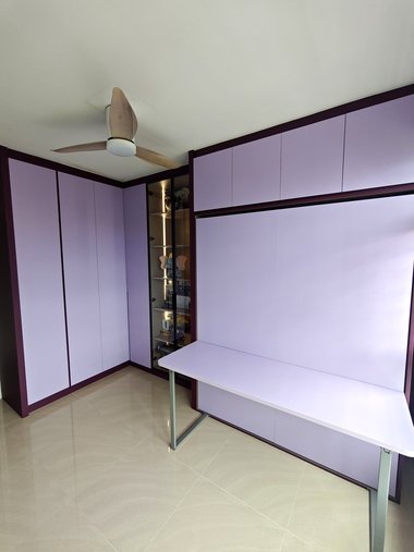 A completed study wall with a matching desk in front of the closed Murphy bed.