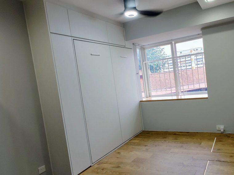 A wall bed with the cabinets built around it, photographed by the customer in their own bedroom.
