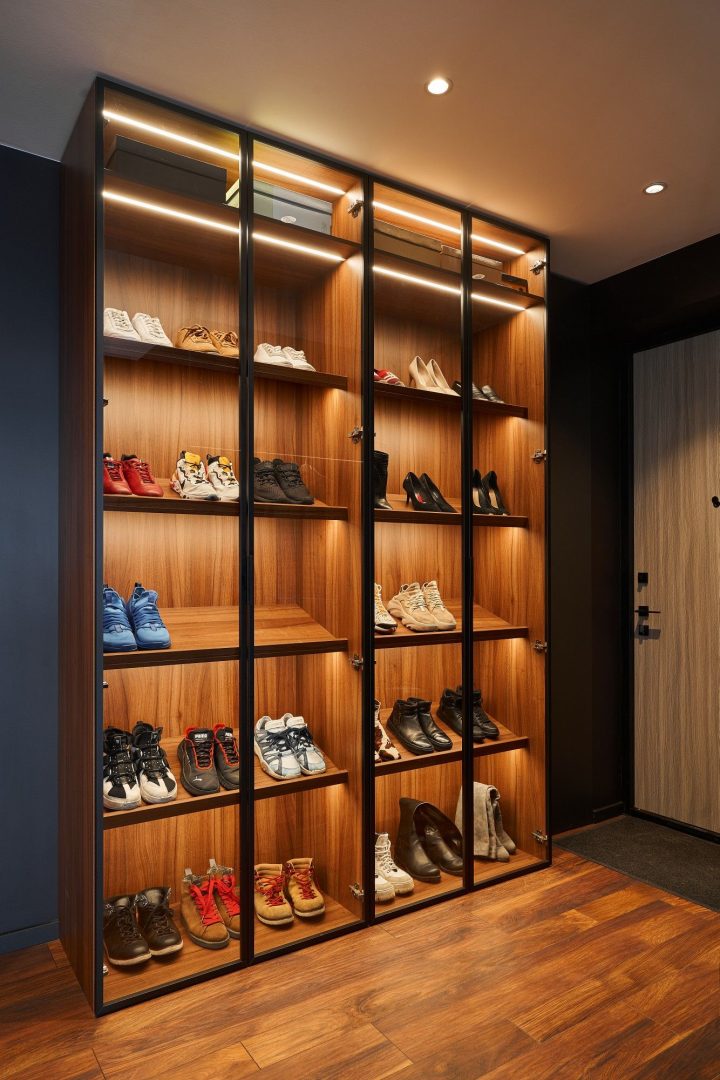 Amazing walk-in closet built-in cabinets with custom lighting showcasing  designer bags finished with glass-f…