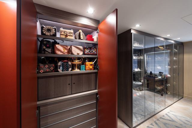 Amazing walk-in closet built-in cabinets with custom lighting showcasing  designer bags finished with glass-f…