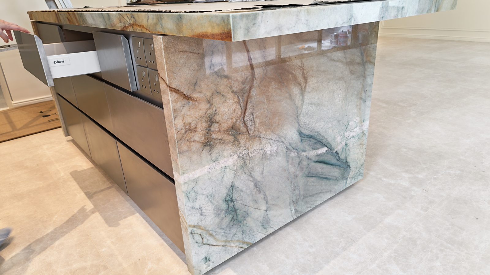 Mitred stone waterfall island end with soft-close drawer boxes below