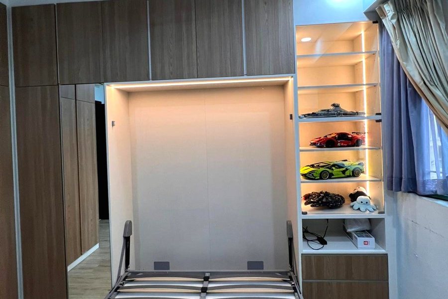 A wall bed recess with storage built above it in a Singapore HDB bedroom.